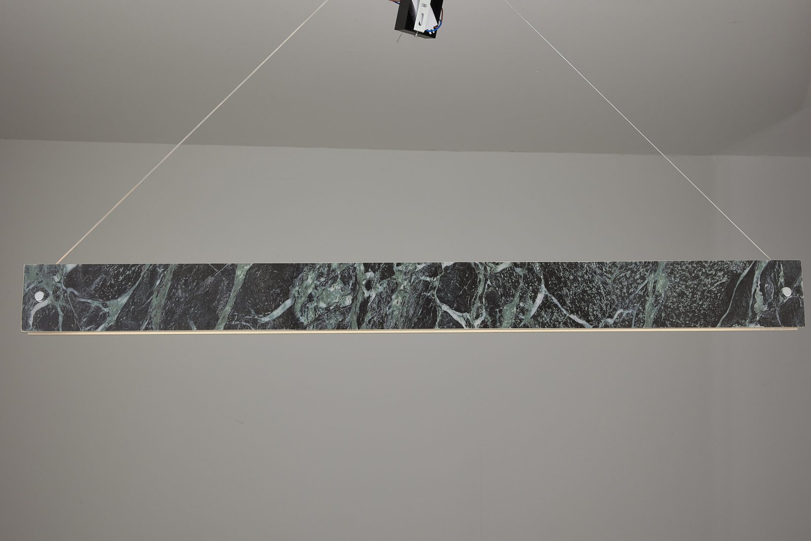 Linear marble-effect decorative lighting installed for collection review