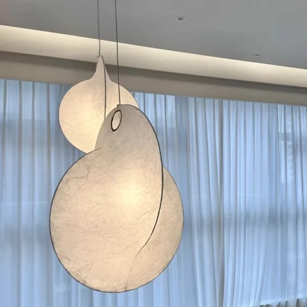 Illuminated sculptural silk pendant shades suspended at different heights